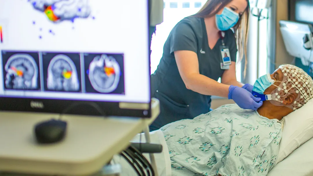 Provider attending patient before brain scan procedure