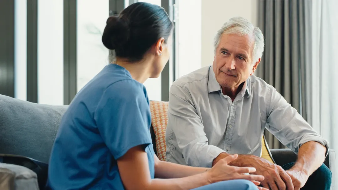 Nurse talking with older male patient