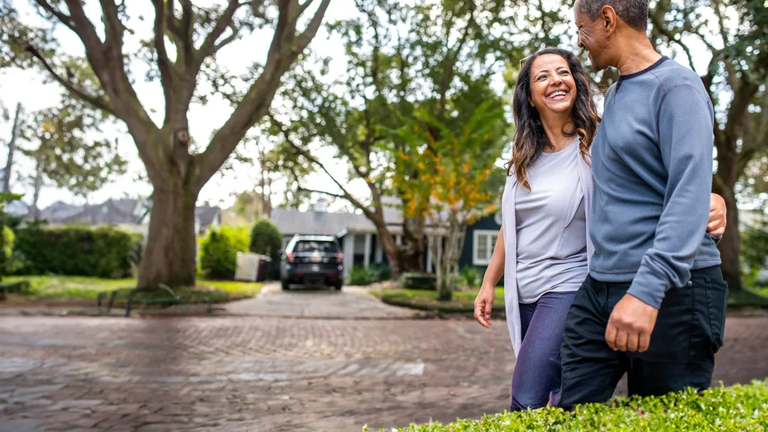 Man and woman walking in neighborhood