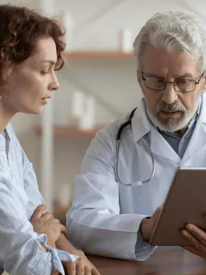 A Provider Goes Over a Patient's Chart with Her on a Tablet.