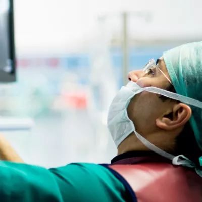 Doctor Looking at Monitor in Surgery.