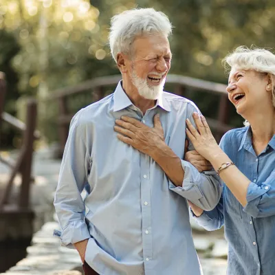 A mature couple walking outdoors.