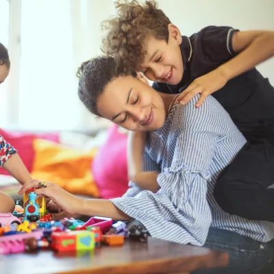 A mom playing with her kids. 