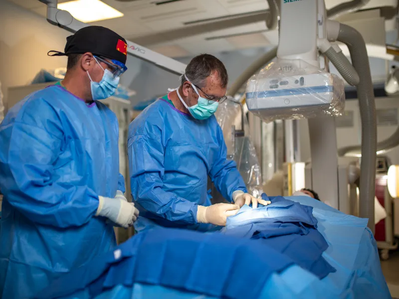 Neuro physicians performing Bi-plane procedure.