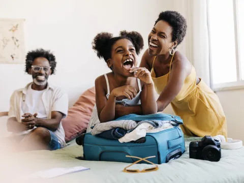 A family having fun while packing luggage