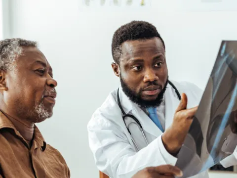 Doctor showing man an X-Ray of his lungs
