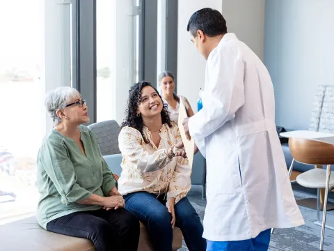 Physician greeting patient and family