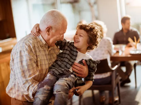 Grandfather playing with grandson.
