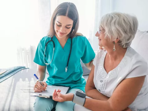 Nurse checking patients blood pressure.