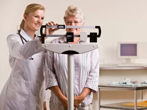 Woman on a scale at a doctor's office