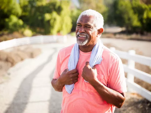 A senior gentleman taking a breather from exercise