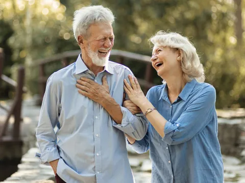 A mature couple walking outdoors.