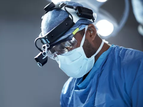 A doctor focused while doing his surgery