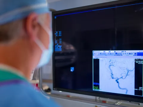 Neurointerventional radiologist using a C-ARM machine to perform a procedure.