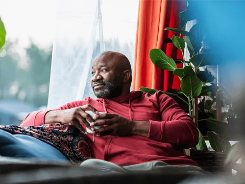 man looking out window