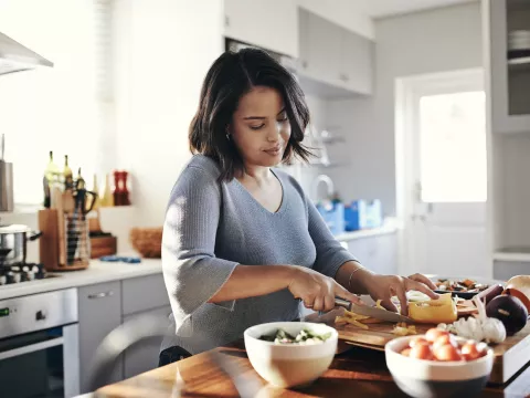 A woman preparing a healthy meal. 