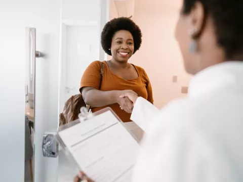Woman shaking her doctor's hand.