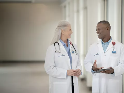 Two doctors talking in a hallway at a hospital