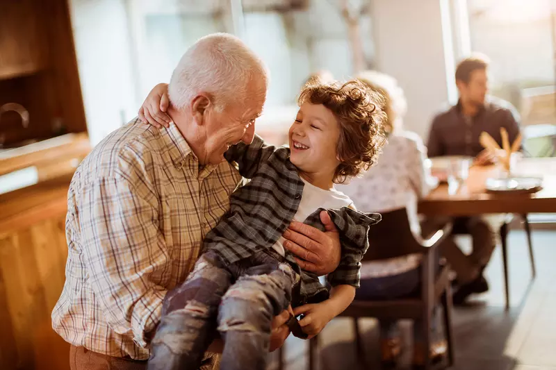 Grandfather playing with grandson.