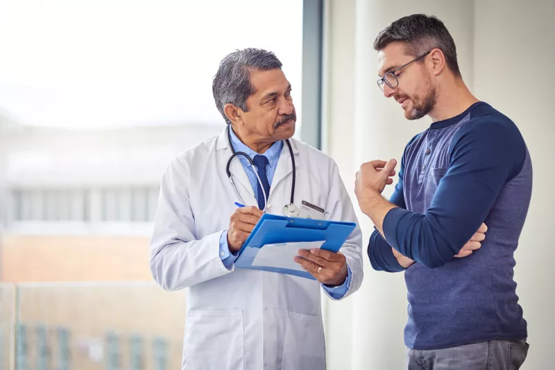 Adult White Man Discusses His Condition With A Doctor