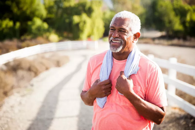 A senior gentleman taking a breather from exercise