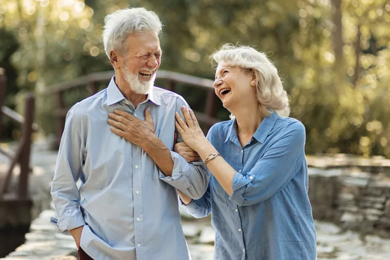 A mature couple walking outdoors.