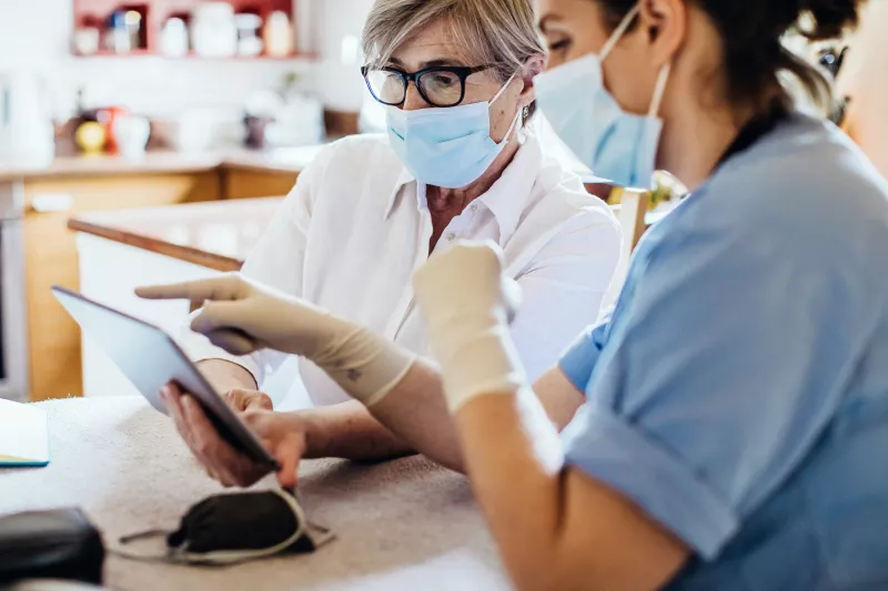 A woman reviews her test results with her provider safely.