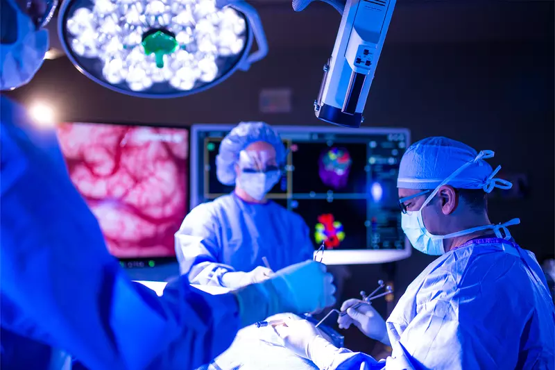 Neurosurgeon team in an operating room performing a surgery.