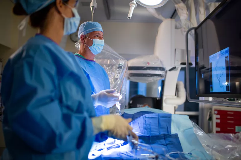 Neuro surgeon performing a procedure using a C-Arm.