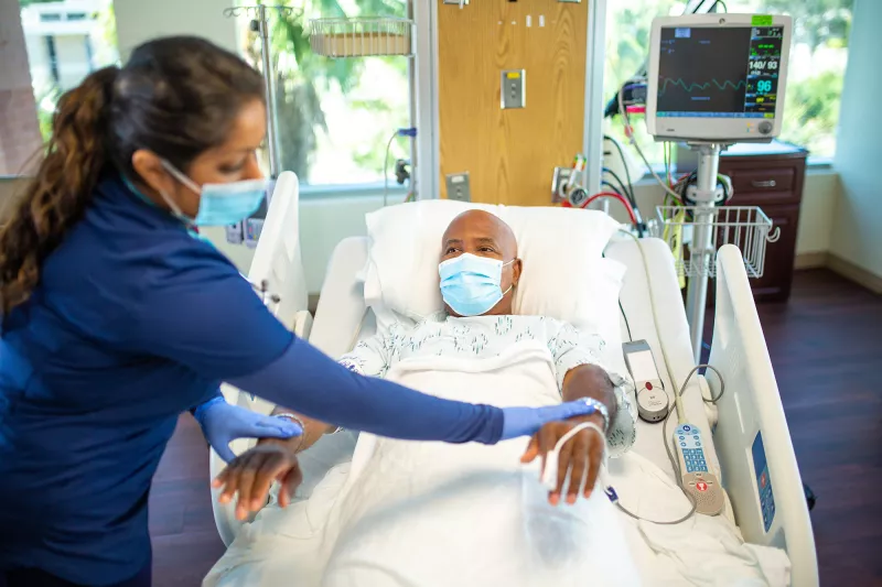 Nurse performing examination on a stroke patient.