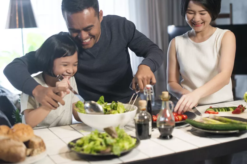 A family makes a meal together