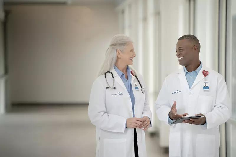 Two doctors talking in a hallway at a hospital