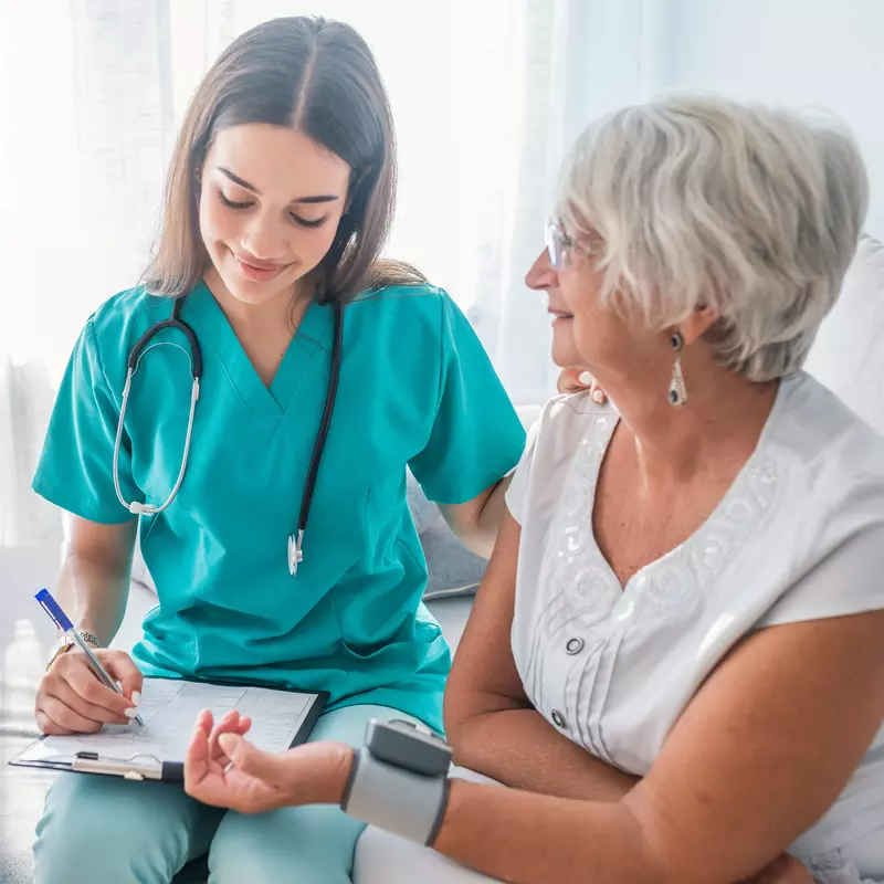 Nurse checking patients blood pressure.