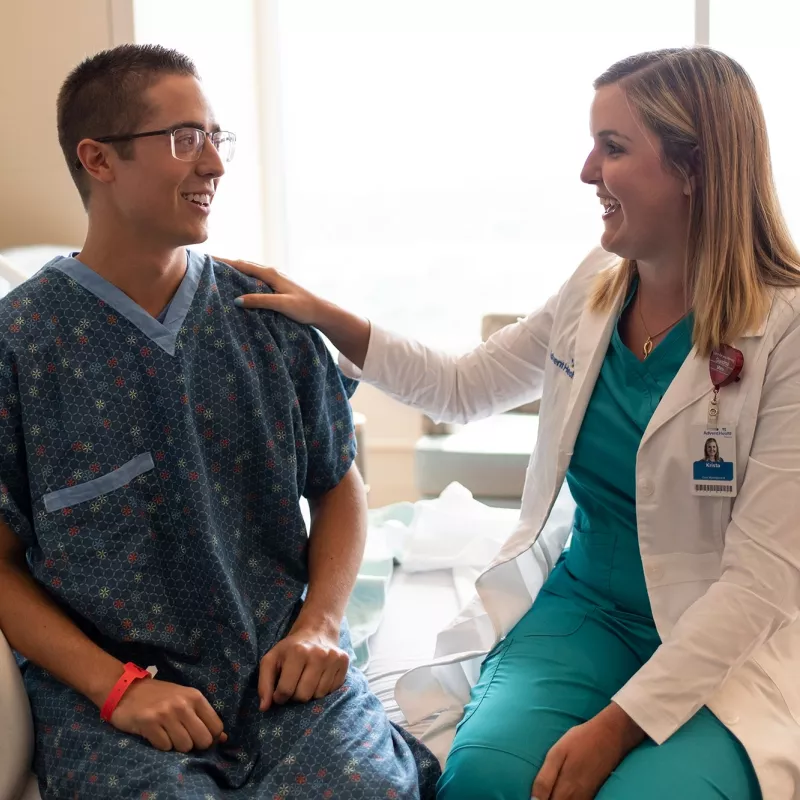 Doctor visits her patient in his room and reassures him.